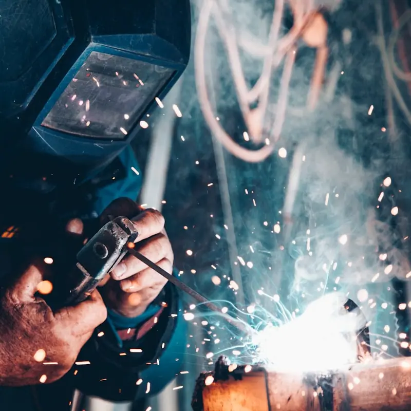 Welder working on a trailer frame
